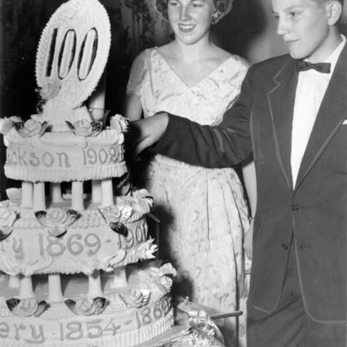 [Betty Lou and Willard L. Johnson Jr., fourth generation members of Calvary Presbyterian Church, cutting an anniversary cake at the church's centennial banquet]