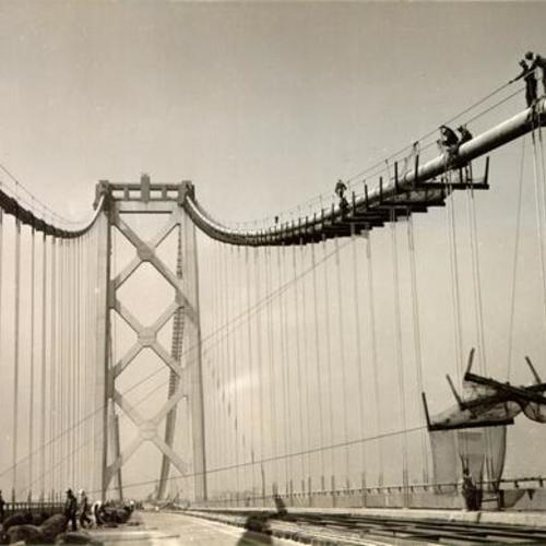 [Construction workers removing catwalk from the San Francisco-Oakland Bay Bridge]