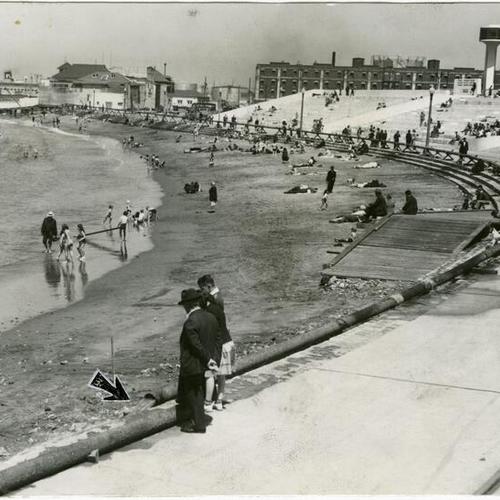 [View of Aquatic Park beach shows how 6,000 cubic yards of sand is being pumped through 1000-foot pipe]
