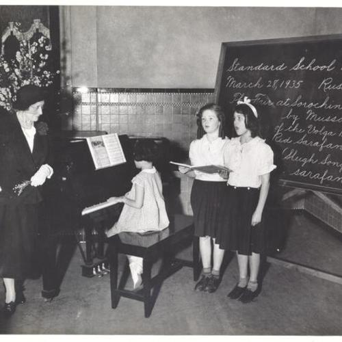 [Mary Garden observing students singing at Raphael Weill School]