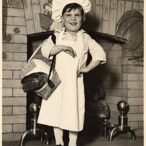 [Boy dressed as a baker at one of the Community Chest agencies]