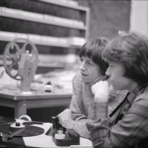 [Veronica Selver and Lucy Massie Phenix at Moviola film editing table working on the film, Word is out]