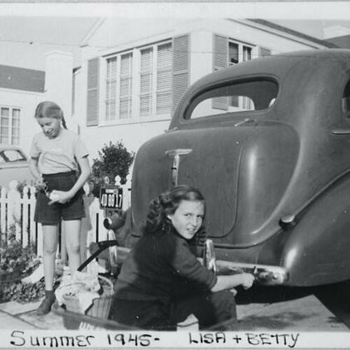 [Lisa and Betty washing cars for fifty cents during Summer of 1945 on Stratford Drive]