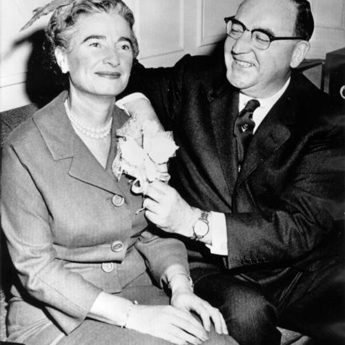 [Mrs. Pat Brown gets a corsage from her Attorney General husband at a press conference]
