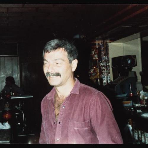 Portrait of bartender behind bar