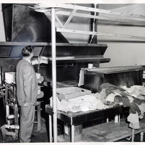 [Supervisor J. Eugene McAteer inspecting an unused kitchen at the Youth Guidance Center]