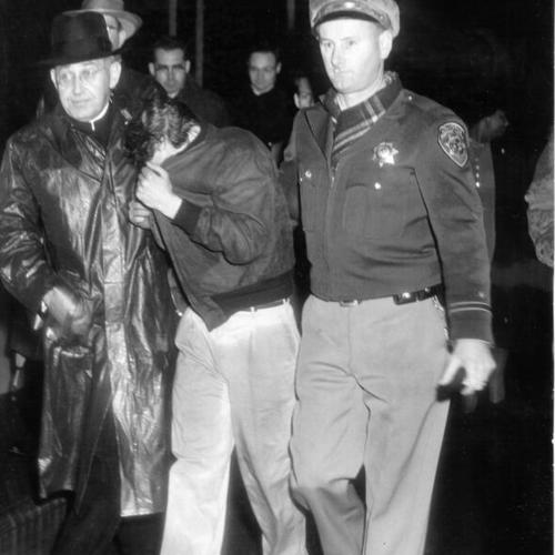 [H. F. Ward, priest from St. Alberts College, and State Highway Patrolman Luke Morley escorting George Bentley off the San Francisco-Oakland Bay Bridge after he threatened to commit suicide]