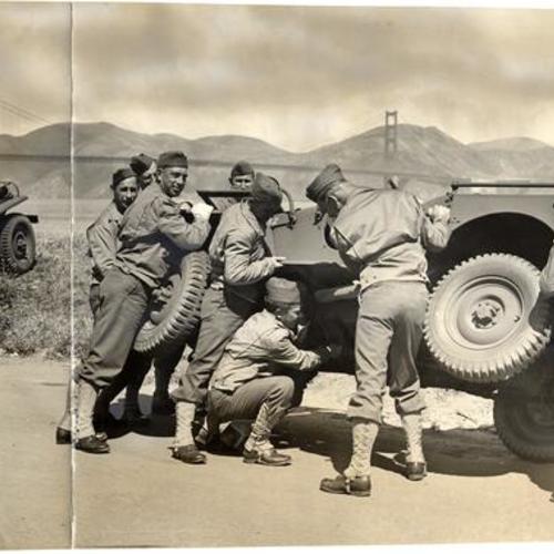 [Group of soldiers lifting a jeep at the Presidio]