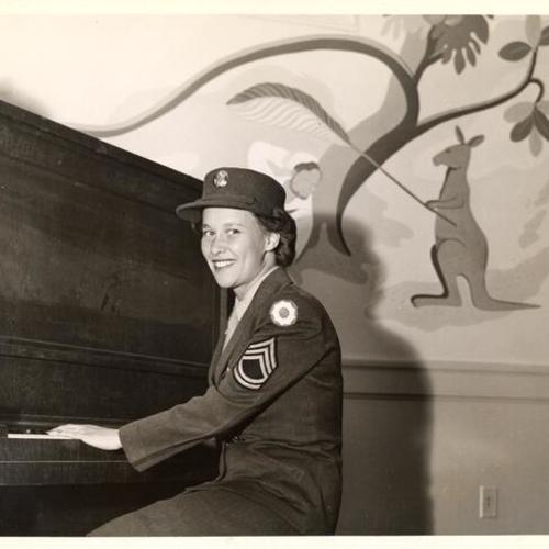 [Sergeant Beryl Smith at the piano previewing the CIO Servicemen's Center]