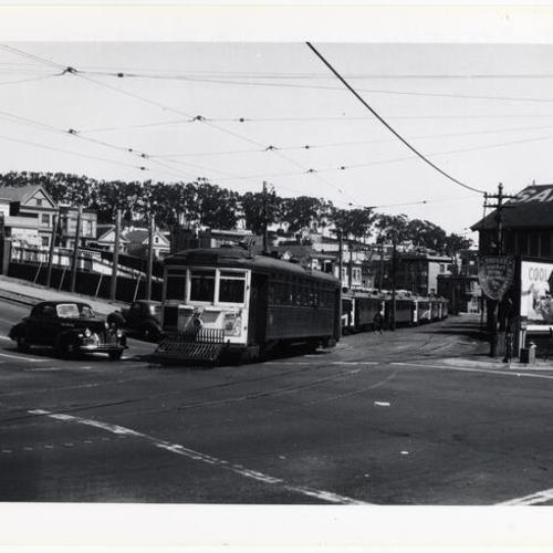 [Fulton and Masonic avenue looking northeast at #5 line car 825 emerging from McAllister car house]