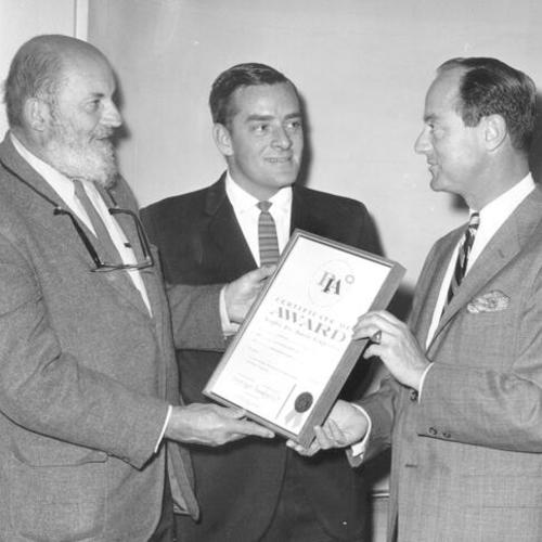 [Ansel Adams with Chuck Mayhew and Robert Loew as the three men look at a PIA Award Certificate]