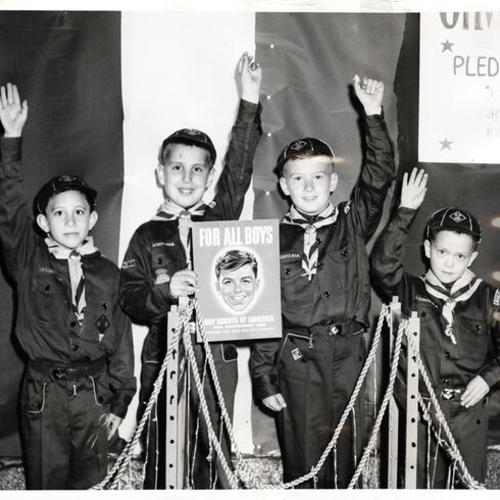 [Cub Scouts Richard Ragni, David Frandin, Paul Stanbrough, and Michael Perrin standing by the model they made of the Golden Gate Bridge for the 49th anniversary of the founding of Scouting in America]