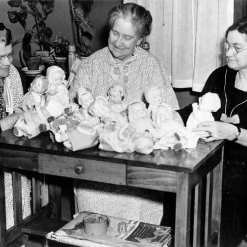 [Three residents of Laguna Honda Home making doll clothes for poor children]