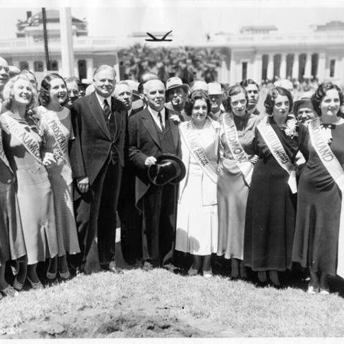 [Herbert Hoover, James Rolph and beauty pagent winners pose at Bay Bridge groundbreaking ceremony on Yerba Buena Island]