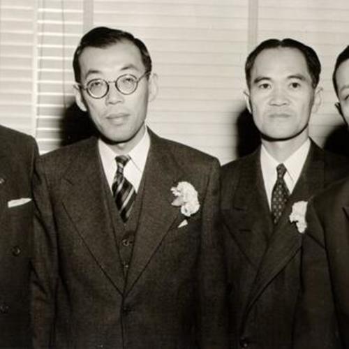 [Mr. Ferroggiaro, of Bank of America, standing with Sanwa Bank executives Shigeo Arimitsu, George J. Korenaga and K. Yamamoto]