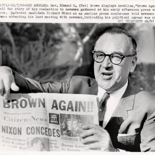 [Governor Edmund G. Brown displaying headline announcing his re-election over Nixon]