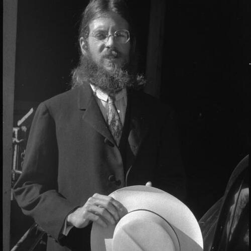 Stuart Jenkins in suit holding Panama hat outside, Mountain View