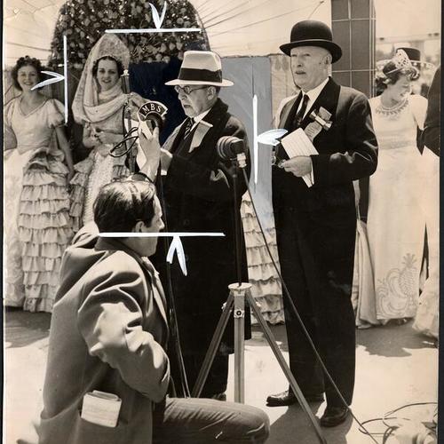 [Joseph Strauss at the microphone with Queen Empress Vivian Sorenson and Chairman William P. Filmer]