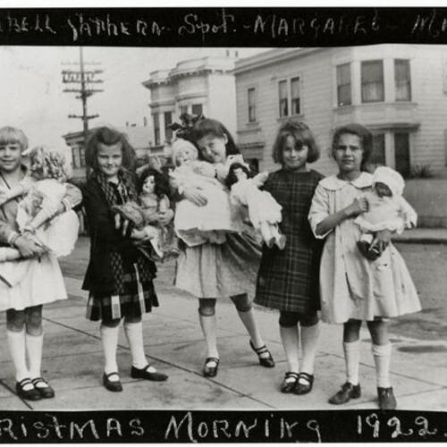 [Girls holding their dolls on Christmas morning at corner of Eddy and Broderick Streets in 1922]