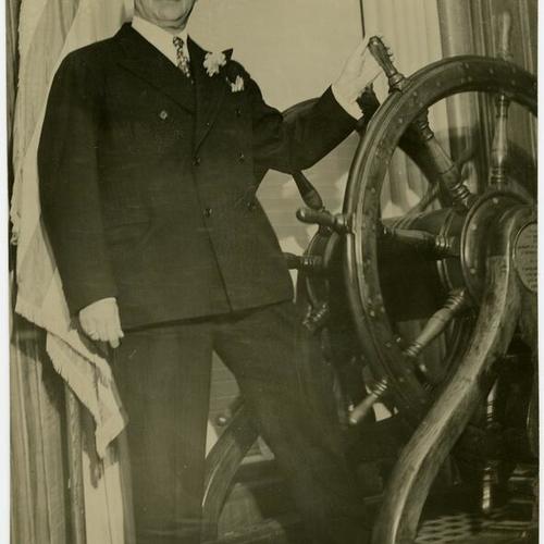 [A.P. Giannini poses at the helm]