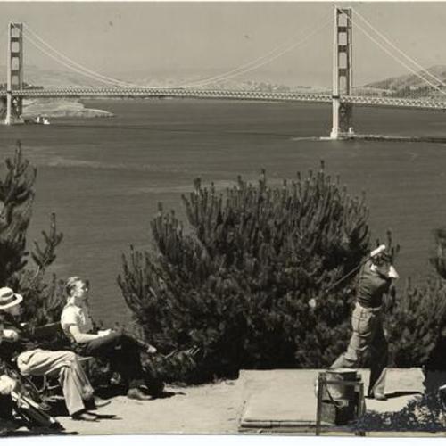 [Golfers at Lincoln Park Golf Course, with view of Golden Gate Bridge in background]