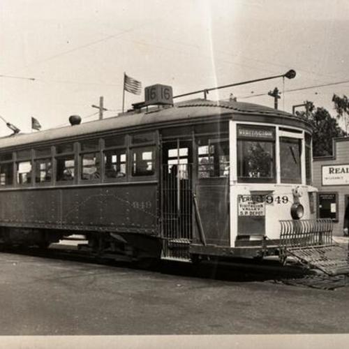 [Bayshore boulevard in Visitacion Valley looking northeast at conductor changing fender on #16 line car 949 at terminal]
