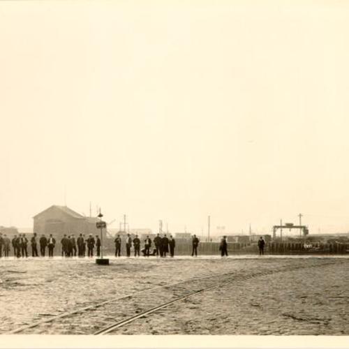 [Group of men standing on Pier 46]