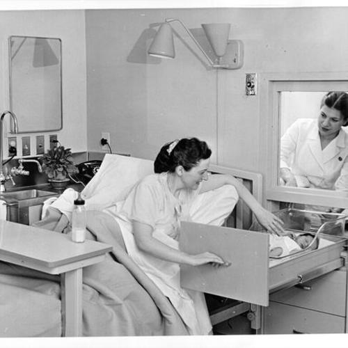 [Maternity patient and nurse in Kaiser Hospital's state-of-the-art nursery]