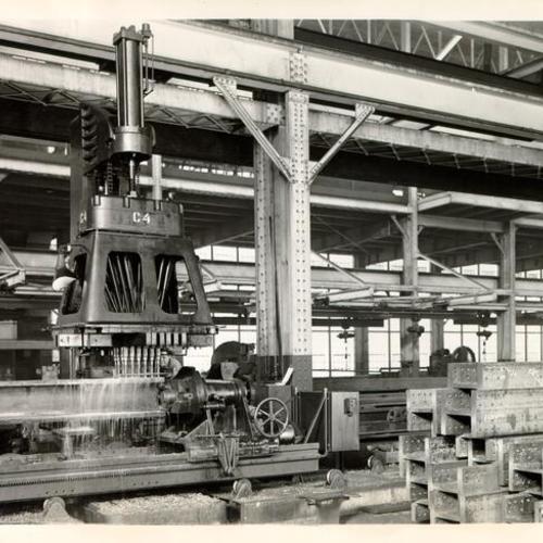 [L. R. Magness drilling a hole in a steel column being fabricated for the O'Connor, Moffatt & Company store in San Francisco]