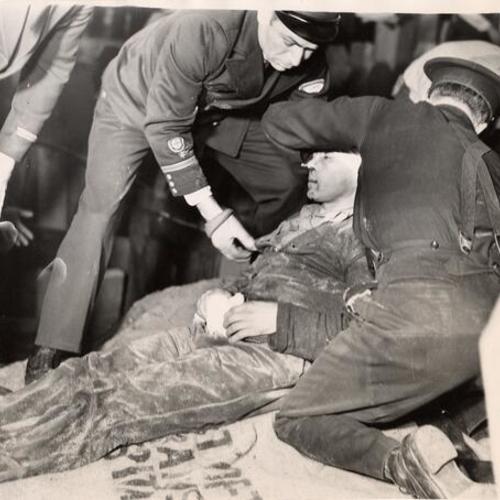 [Tony Rodrigues being placed on stretcher by officers near Fleishhacker zoo after a cave-in]