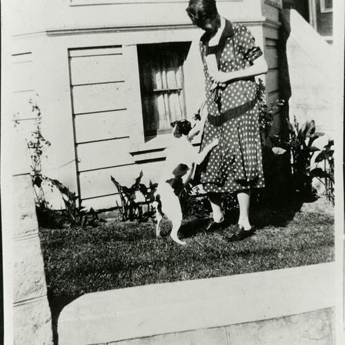 [Lorraine's mother, Minnie, playing with a dog in 1923]