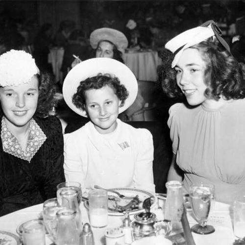 [Elvira Huenergardt, Claire Morris and Jacqueline Morris watching a fashion show at the Clift Hotel]