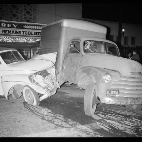 [Scene of an automobile accident on Ocean Avenue and Victoria Street, El Rey Theater in background at night]