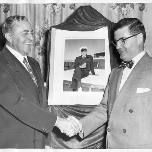 [Real estate developer Henry Doelger being congratulated by George Riley for being chosen as Man of Distinction]