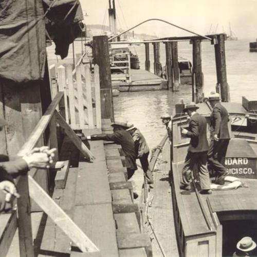 [Men climbing the dock during waterfront strike]