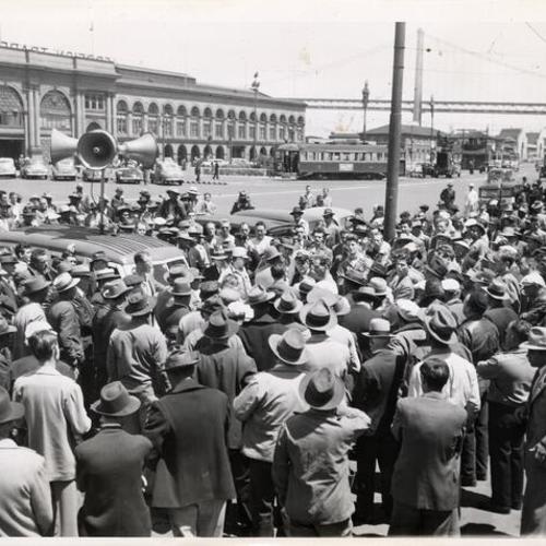 [Maritime workers assembled for a meeting at the waterfront]