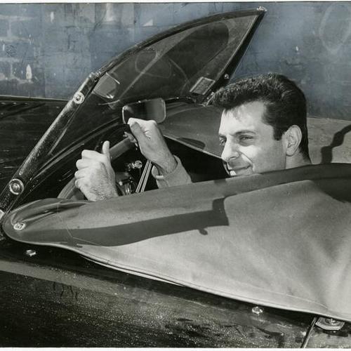 [Mort Sahl drives in Austin-Healy]