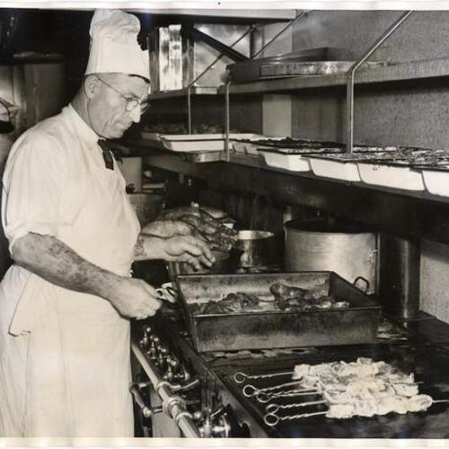 [Chef in kitchen at Veterans Memorial Building preparing food for United Nations conference]