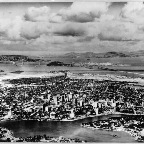 [Aerial view of the bay while San Francisco-Oakland Bay Bridge and Golden Gate Bridge in background]