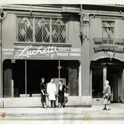 [Four people standing outside of Luchetti meat shop at 780 Valencia Street]