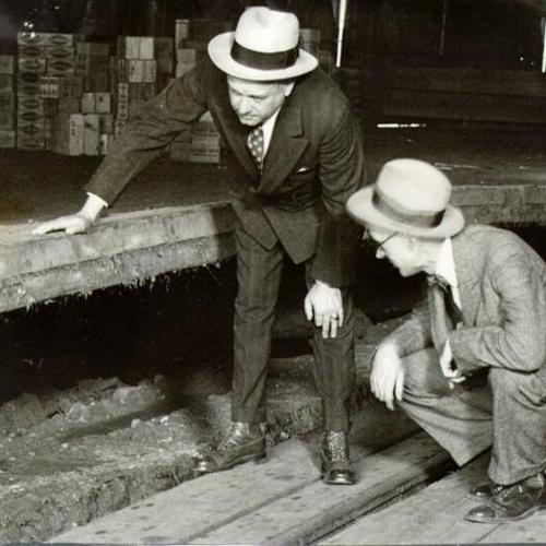 [Two men inspecting a Pier at China Basin]