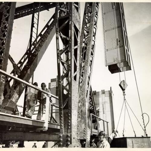 [Golden Gate Bridge construction workers raising steel girder]