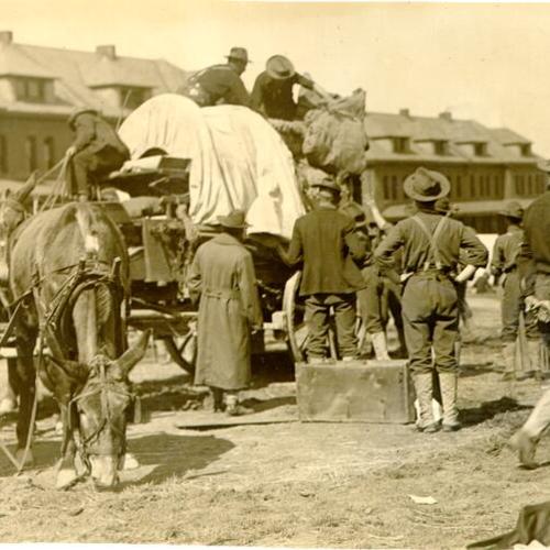 [People loading a wagon at the U. S. Army base at the Presidio]