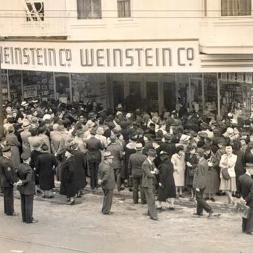 [Crowd of people gathered on Polk Street for opening of new Weinstein Company store]