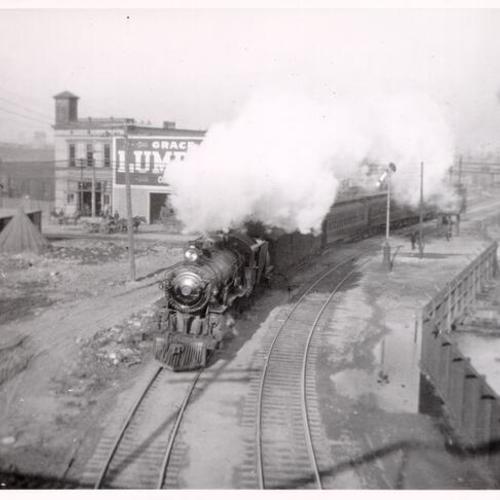 [Train passing by the Grace & Symington Lumber Company at 852 Bryant Street]