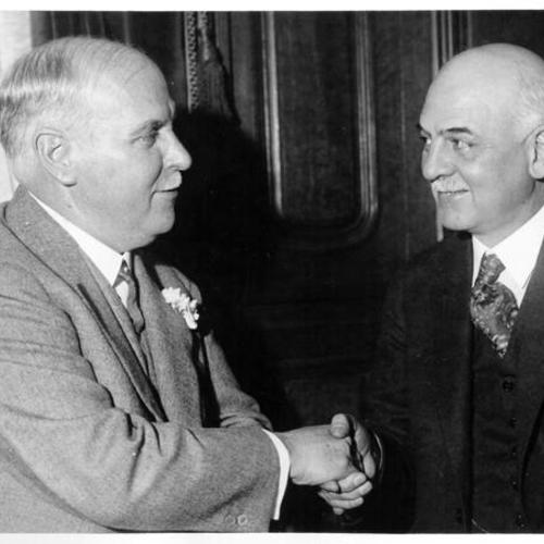 [Governor elect James Rolph, Jr. shaking hands with incoming mayor of San Francisco Angelo J. Rossi]