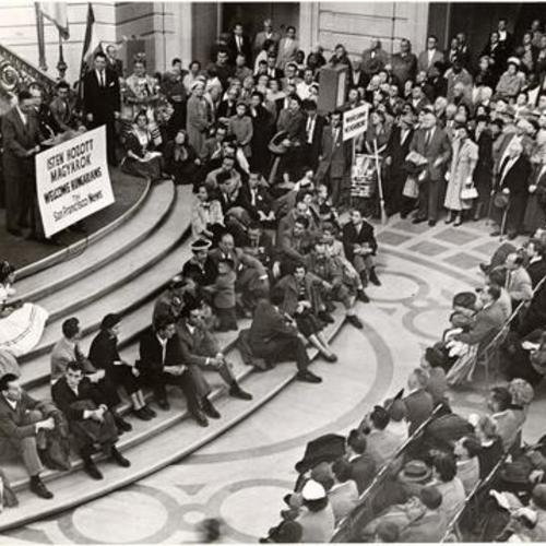 [Hungarian refugees sitting on the grand Rotunda staircase at City Hall]
