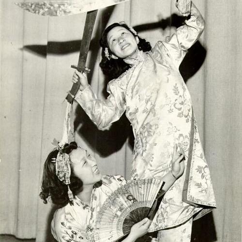 [Mabel and Ida Lew partaking in an intricate dance of the swords at the Rice Bowl Party