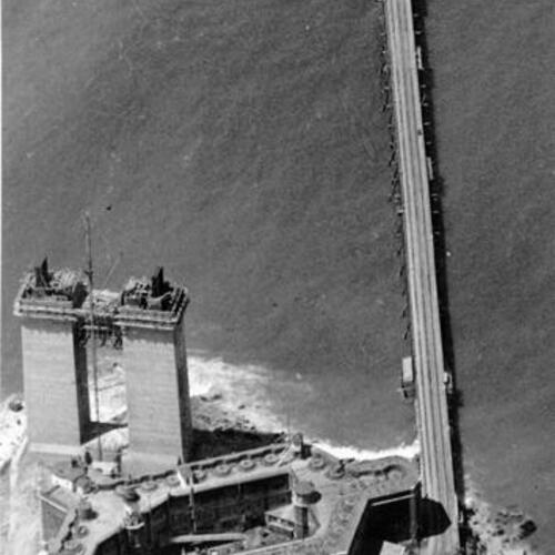 [Aerial view of Golden Gate Bridge trestle bridge with Fort Point and San Francisco anchorage in foreground]