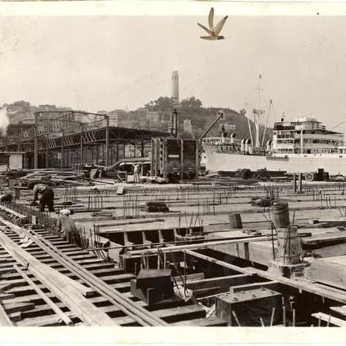  pier under construction with Coit Tower visible in the background]